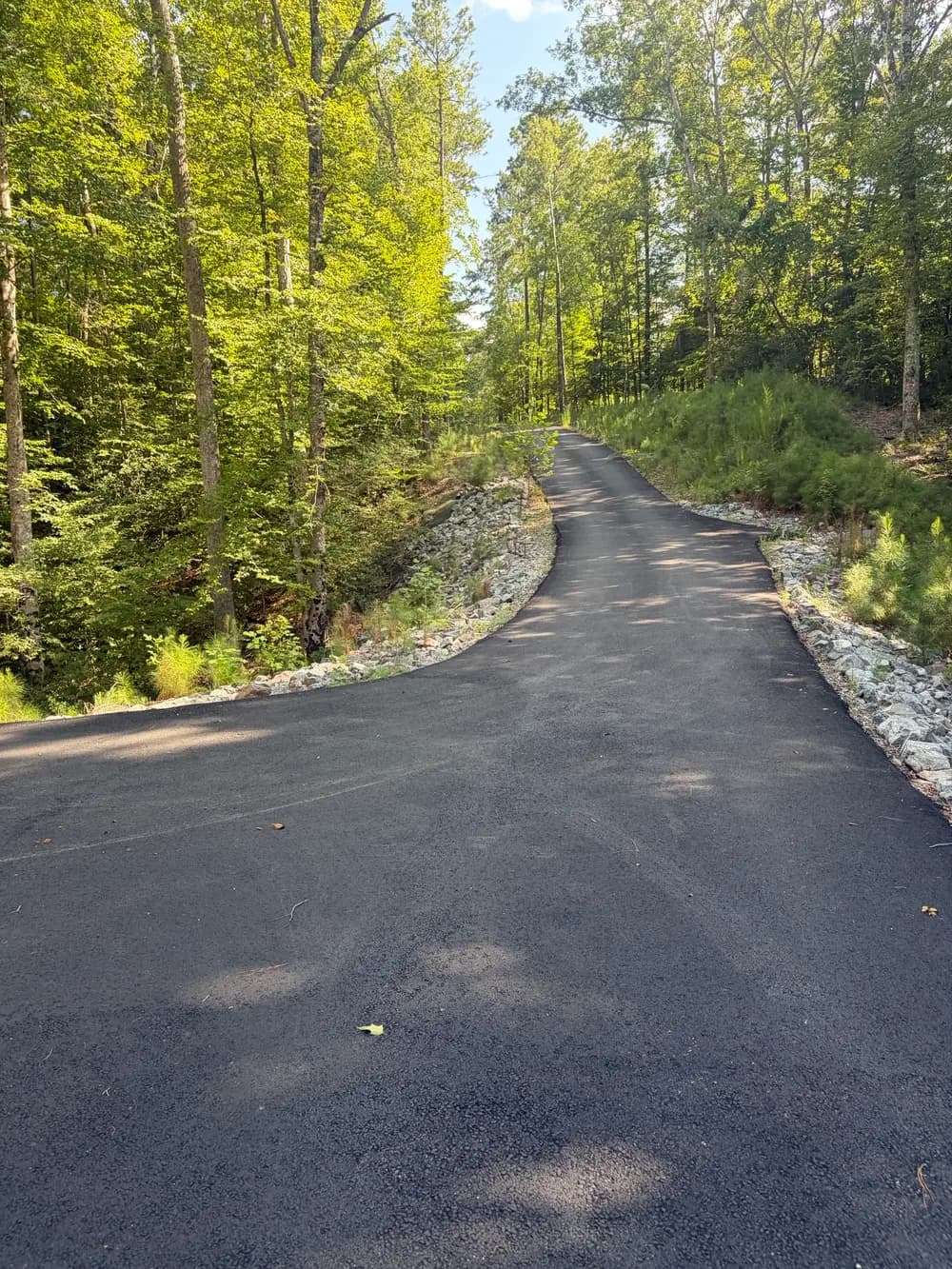 Gallery photos for Fixing a Builder's Rip Rap Mistake on a Sloped Driveway in James City County: Image #1
